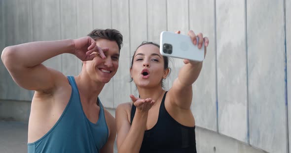 Fit Sports Couple Young Man and Woman Runners Making Selfie Photos on Smartphone After Sport Fitness alt