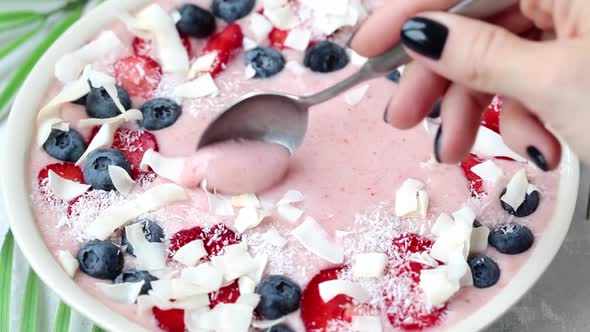 Berry smoothie bowl with strawberries, blueberries and coconut.  alt