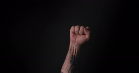 Man Hand. Fist on Black Background. alt