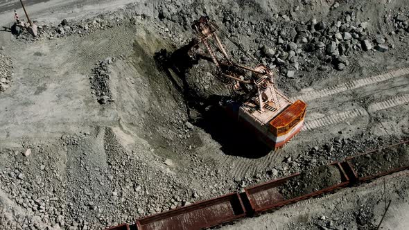 Large Excavator Loading Rock Formation It to the Freight Train alt