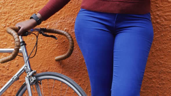 African american using her smartphone in street alt