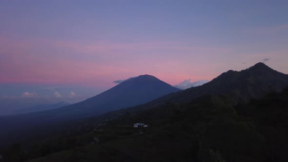 Agung Mount at sunset 4K time lapse day to night clouds running over mountain volcano Bali Indonesia