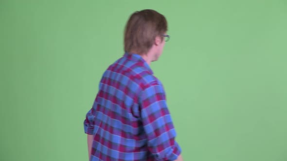 Young Hipster Man with Eyeglasses Looking Guilty and Walking Away alt