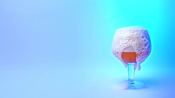 Beer Pouring Into A Glass On A Blue Background