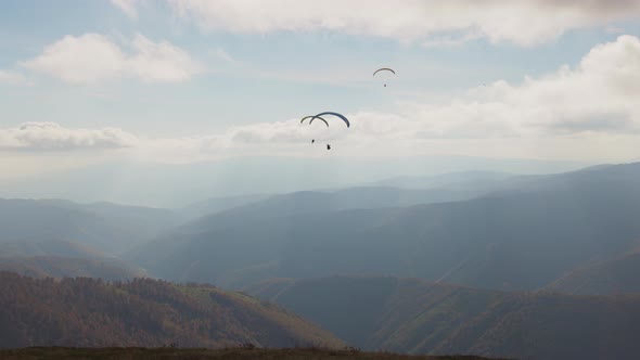 Paragliding Active Sport Against Giant Mountains in Highland alt