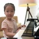 Medium Close up shot asian toddler practicing piano. - VideoHive Item for Sale