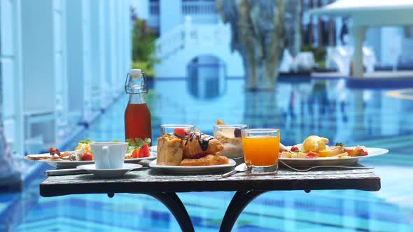 Table with Delicious Food By the Beautiful Blue Pool Travel in Resort alt
