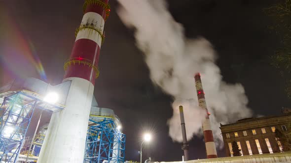 Large chimneys smoke in a large enterprise, tilt time-lapse alt