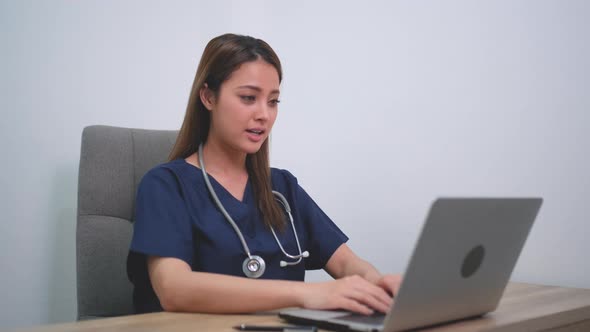 Beautiful doctor woman use laptop to consulting for patient via online meeting alt