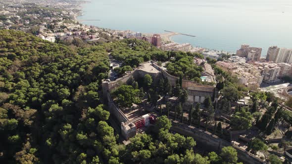 Medieval Gibralfaro Castle ruins, sweeping city views from hilltop; aerial