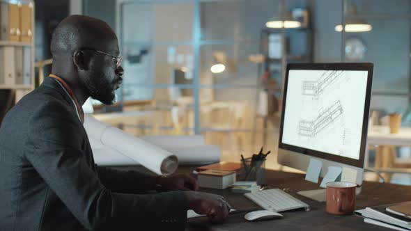 African American Engineer Working on Computer at Night in Office alt