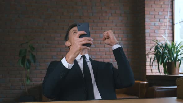 Portrait of Businessman Using Smartphone
