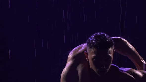 Contemporary Ballet Man Performs Elements of Modern Choreography Standing on Surface Water in Rain alt