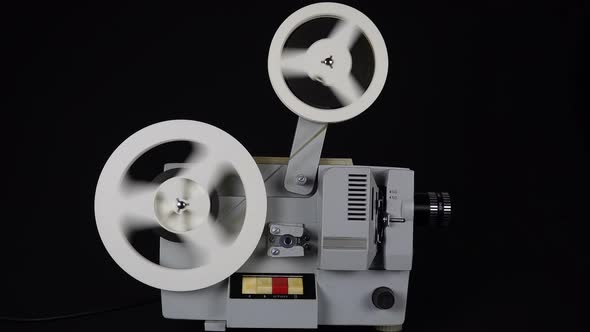 Rewinding Tape In An Old Movie Projector.