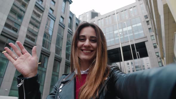 Pretty Young Woman Smiling Making a Video Call on Smartphone Wave a Hand. Beautiful Happy Bussines alt