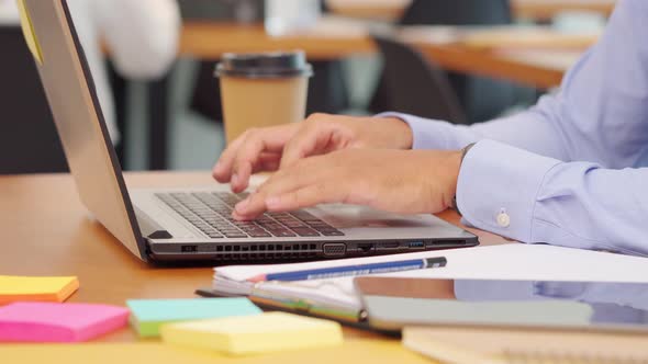 Professional business man working and typing on keyboard at workplace alt