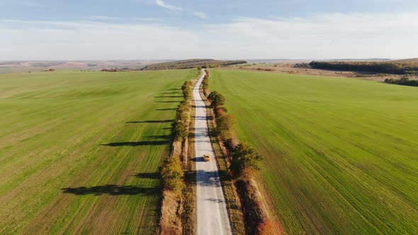 Aerial View of Autumn Road Car. Skyl View Country Road in Autumn. Field and Highway Road Drone View