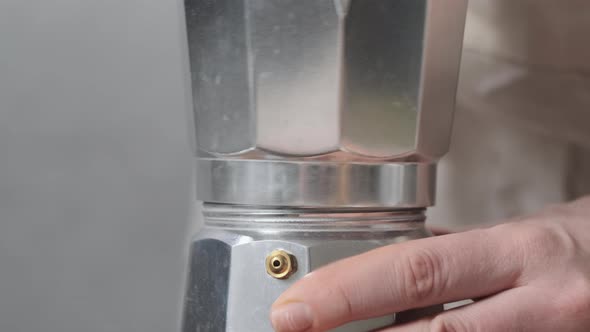 Close Up Woman or Girl Turn Out Geyser Coffee Maker to Pour Water and Put Ground Coffee in It alt