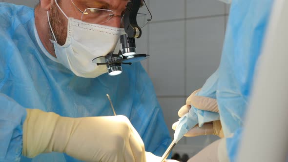 Professional Dental Surgeons and Assistant Operating Surgery Case of Broken Jaw in Operating Room at alt