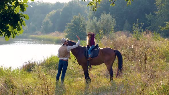 Cowboy and His Daughter on Horseback alt