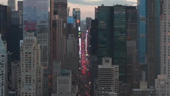 AERIAL: View of 7Th Avenue Traffic and Times Square Over New York City Central Park at Sunset with alt