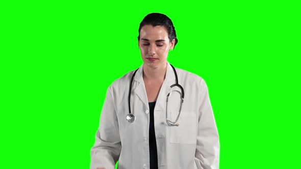 a Caucasian woman wearing surgeon blouse and scrumbs in a green background