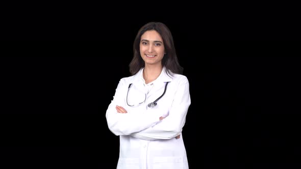 A female doctor smiling and looking at the camera. alt
