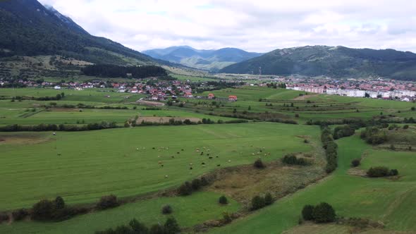 Drone Footage of a Rural Village in the Background in Zarnesti Romania alt
