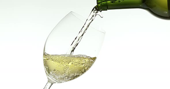 900043 White Wine being poured into Glass, against White Background, Slow motion 4K alt