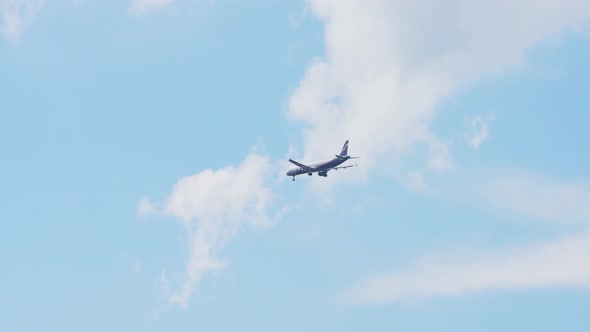 Flying Plane in Blue Sky. alt