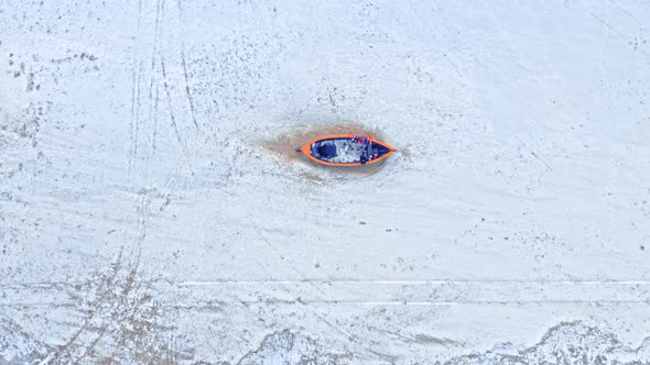 Boat on snowy beach, Baltic sea. Aerial view of winter. alt