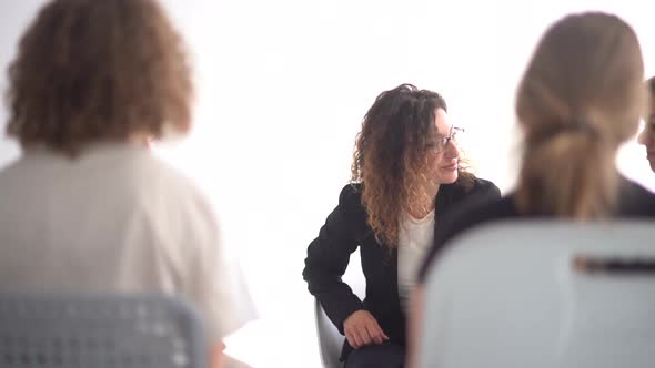 Women Take Each Others Hands During Group Therapy with a Psychologist alt