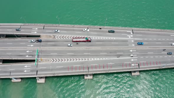 Penang Bridge Malaysia aerial side view with traffic lanes merging in both directions, drone bird's alt