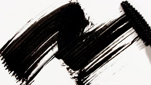 Macro Shot and Slow Motion of a Black Mascara Isolated on White Background alt