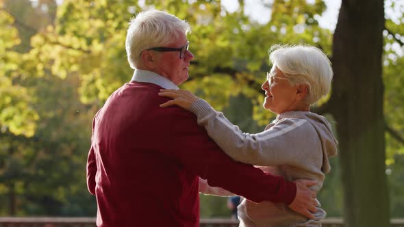 Senior Caucasian Couple Dancing in the Park Happy Retirement Concept Casual Attire alt