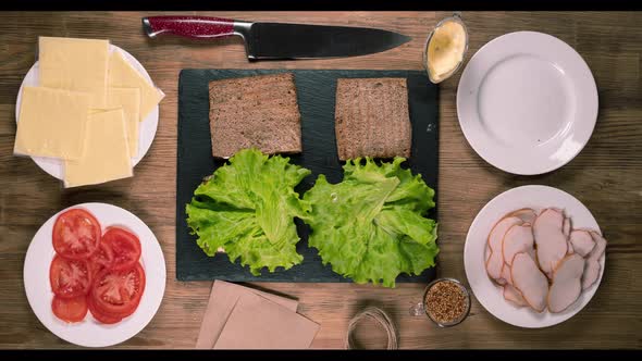 Stop the Movement Make Sandwiches with Meat Cheese Tomatoes and Herbs alt