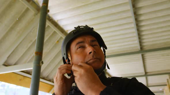 Low angle view of mid-adult caucasian military soldier wearing combat helmet during military trainin alt