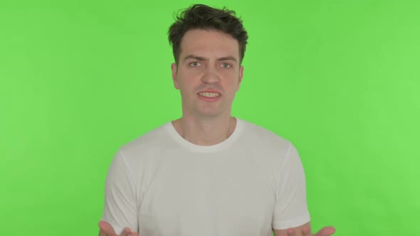 Angry Young Man Abusing on Green Background alt