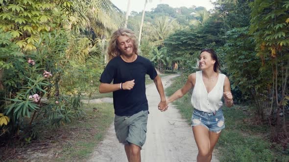 Couple Running On Tropical Island