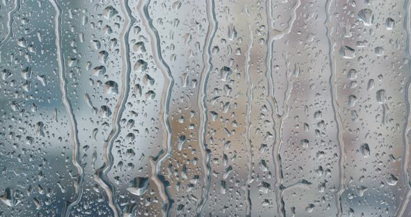Water droplets on glass, rain outside alt