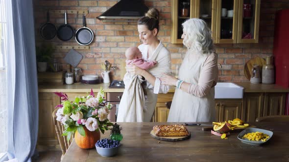 Mother with Child and Grandmother on Kitchen