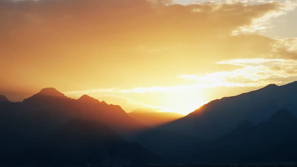 Sunset Behind Silhouetted Mountains