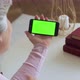 Elderly Mature Woman with Gray Hair and a Video Call on Her Smartphone. Smartphone with a Green - VideoHive Item for Sale