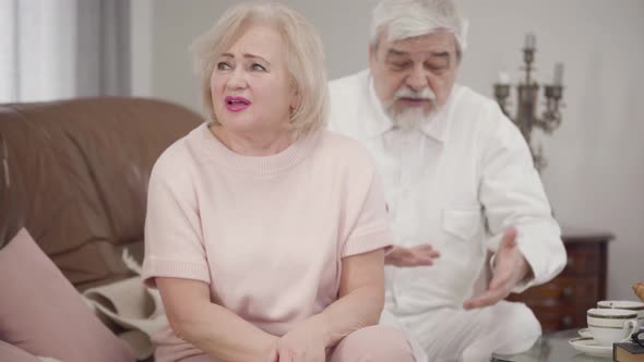 Portrait of Irritated Old Caucasian Woman Talking To Husband, Elderly Wife Complaining To Spouse alt