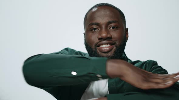 Portrait of Bearded African American Man Dancing on Light Background alt
