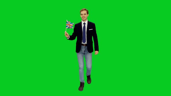 Young Friendly Business Man Walking With Waving Flag Of UK 