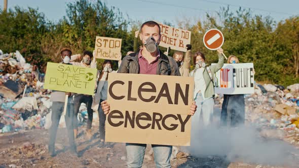 Portrait of Young Man Activist With a Poster Calling to Take Care of the Environment alt