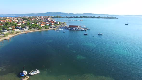 Aerial view of traditional dalmatian town with boats at docks, Sukosan, Croatia alt