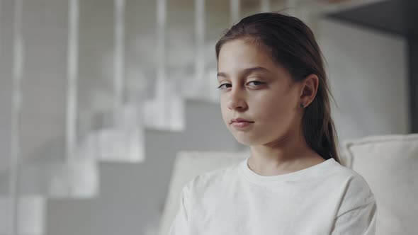 Schoolgirl Turning Head and Looking at Camera with Calm Face alt