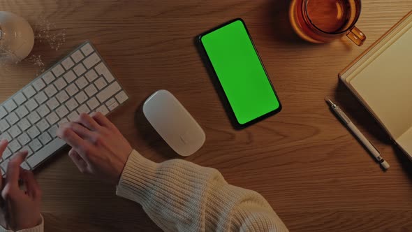Woman Typing on Keyboard and Using Green Screen Mobile alt